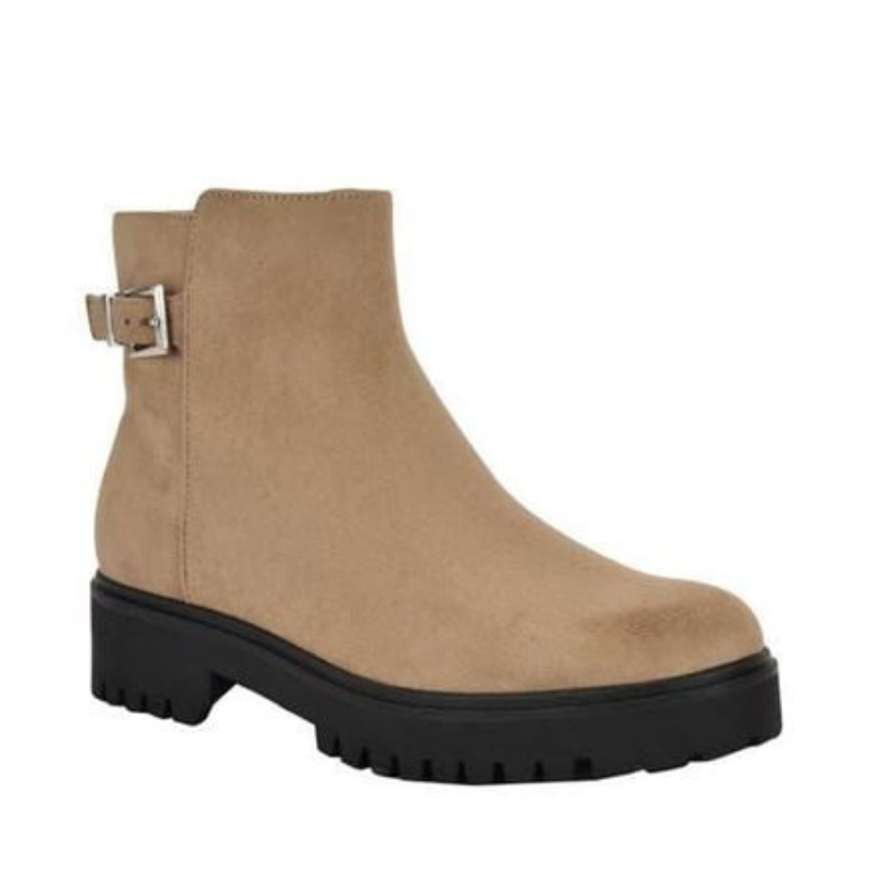 Beige ankle boots with a suede finish, featuring a black lug sole and a side buckle detail.
