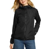 A woman is wearing a black hooded jacket with a front zipper, paired with blue jeans. The jacket is from Eddie Bauer, featuring a simple, functional design.