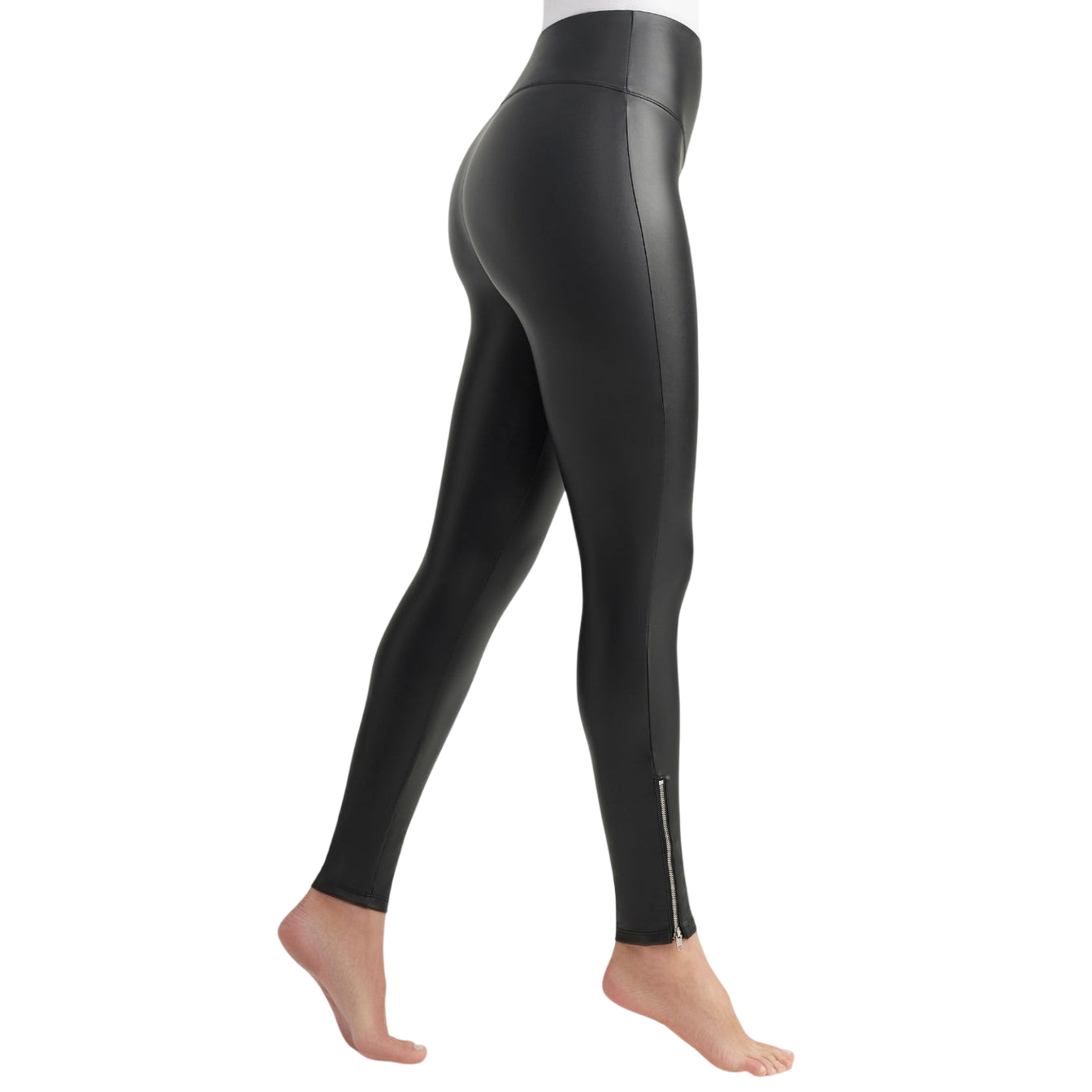High-waisted black faux leather leggings featuring a zipper detail at the ankle, shown on a person standing barefoot from a side angle.