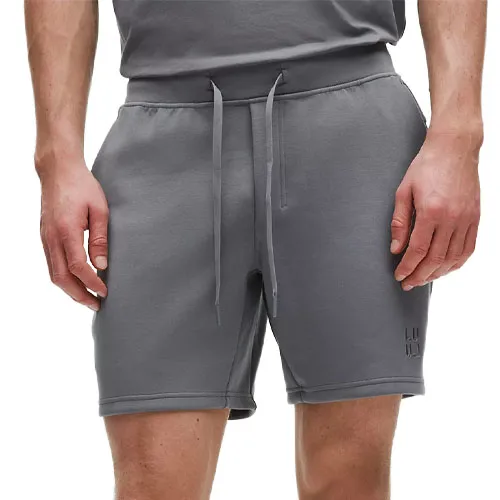 Gray drawstring shorts with side pockets and subtle branding near the hem.