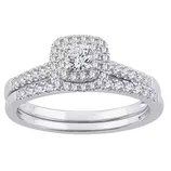 A silver ring set with a central round diamond surrounded by a halo of smaller diamonds, and additional diamonds lining the split shank.