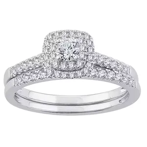 A silver ring set with a central round diamond surrounded by a halo of smaller diamonds, and additional diamonds lining the split shank.