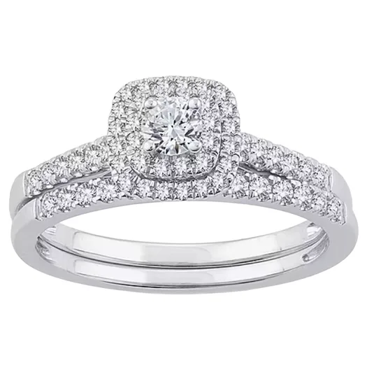 A silver ring set with a central round diamond surrounded by a halo of smaller diamonds, and additional diamonds lining the split shank.