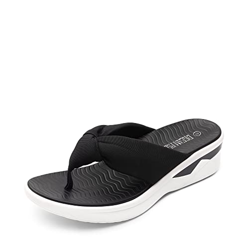 Women's black and white platform flip-flops with a thick sole and textile straps.