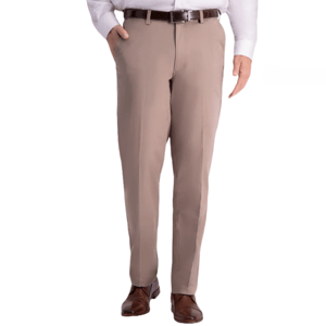 Haggar Men's Dress Pants in a light beige color, featuring a classic fit with flat front design, side pockets, and belt loops. Paired with a brown leather belt and brown dress shoes.