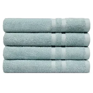 Four light blue bath towels are neatly stacked on top of each other.