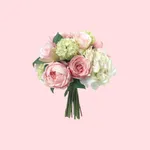 A bouquet of pink and white flowers, including roses and hydrangeas, set against a pastel pink background.