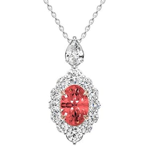 Elegant pendant necklace featuring an oval salmon-colored gemstone surrounded by clear, round-cut stones set in a detailed metal design on a delicate chain.