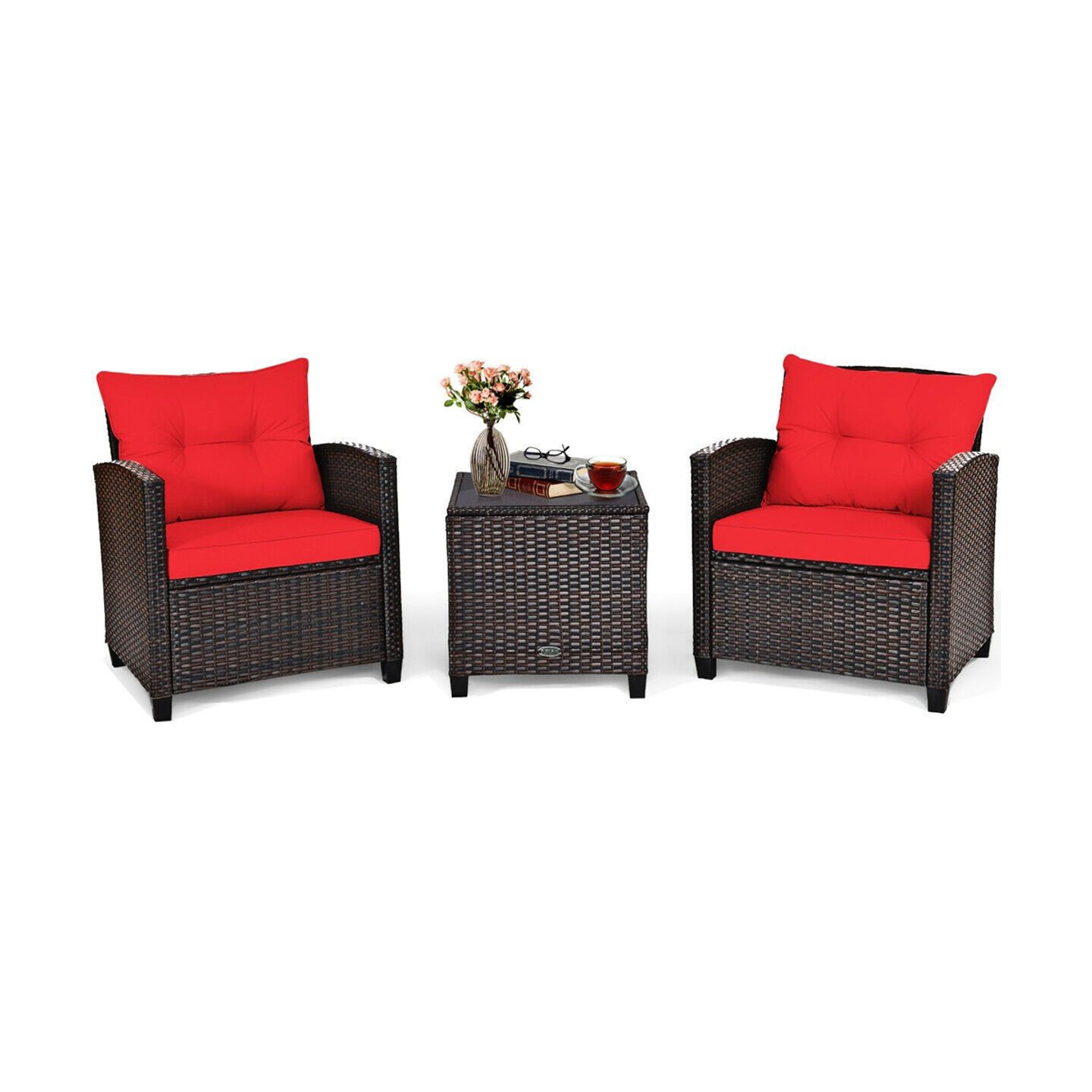 Outdoor patio set with two wicker chairs and red cushions, plus a matching wicker side table with a glass top, featuring a flower vase and a cup of tea.