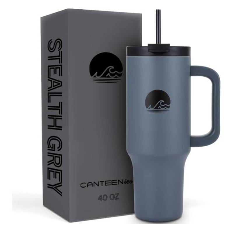 A 40-ounce, gray insulated tumbler with a lid and straw is displayed next to its packaging box labeled \“STEALTH GREY.\“
