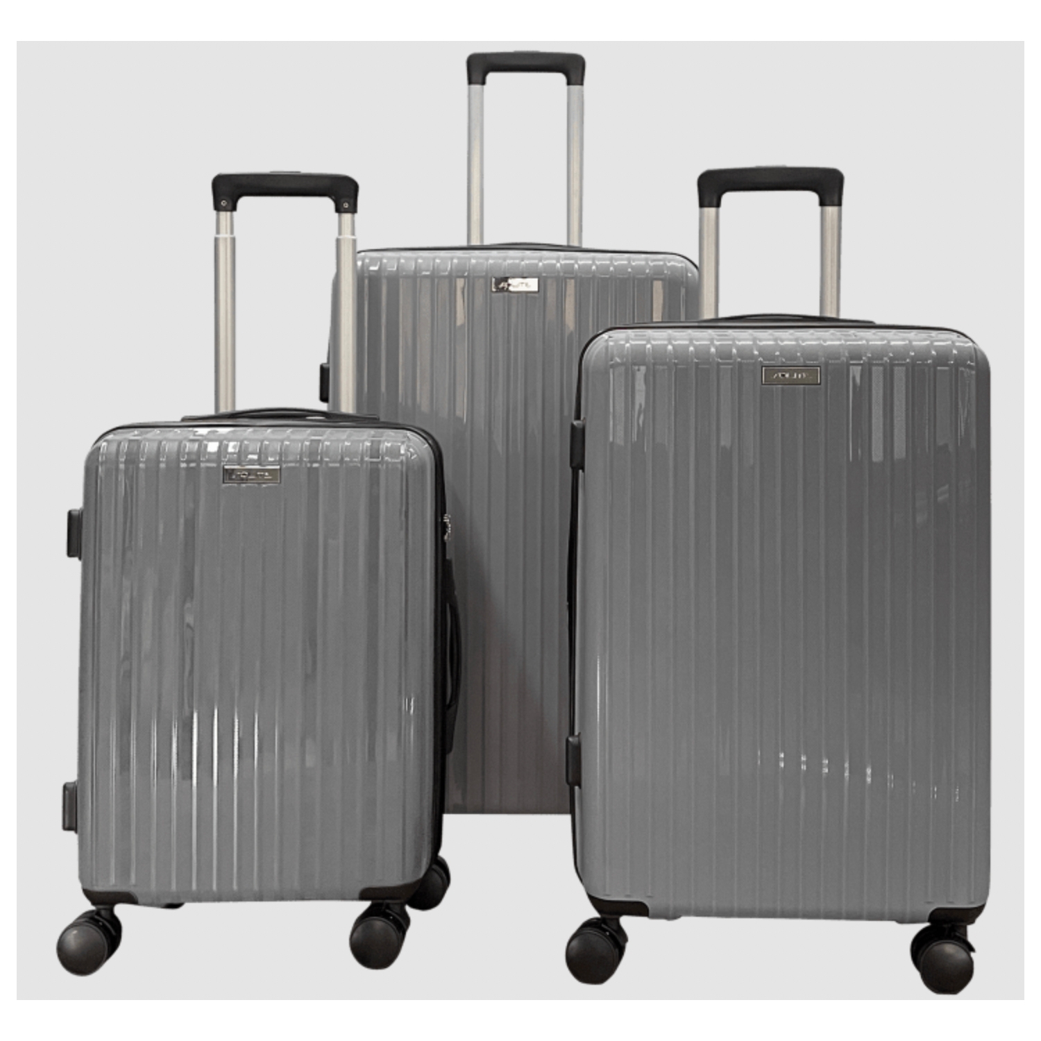 Three grey suitcases of varying sizes with wheels and extendable handles.