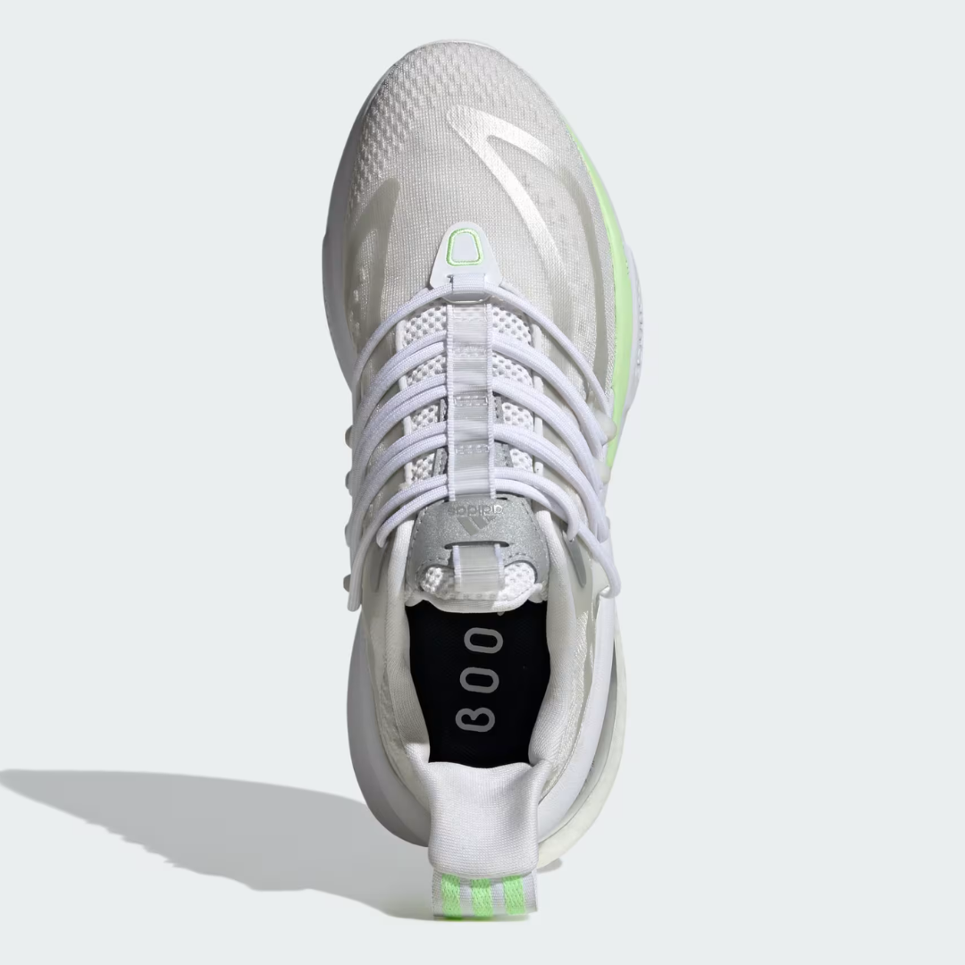 A white athletic shoe with neon green accents and lacing system, viewed from above.