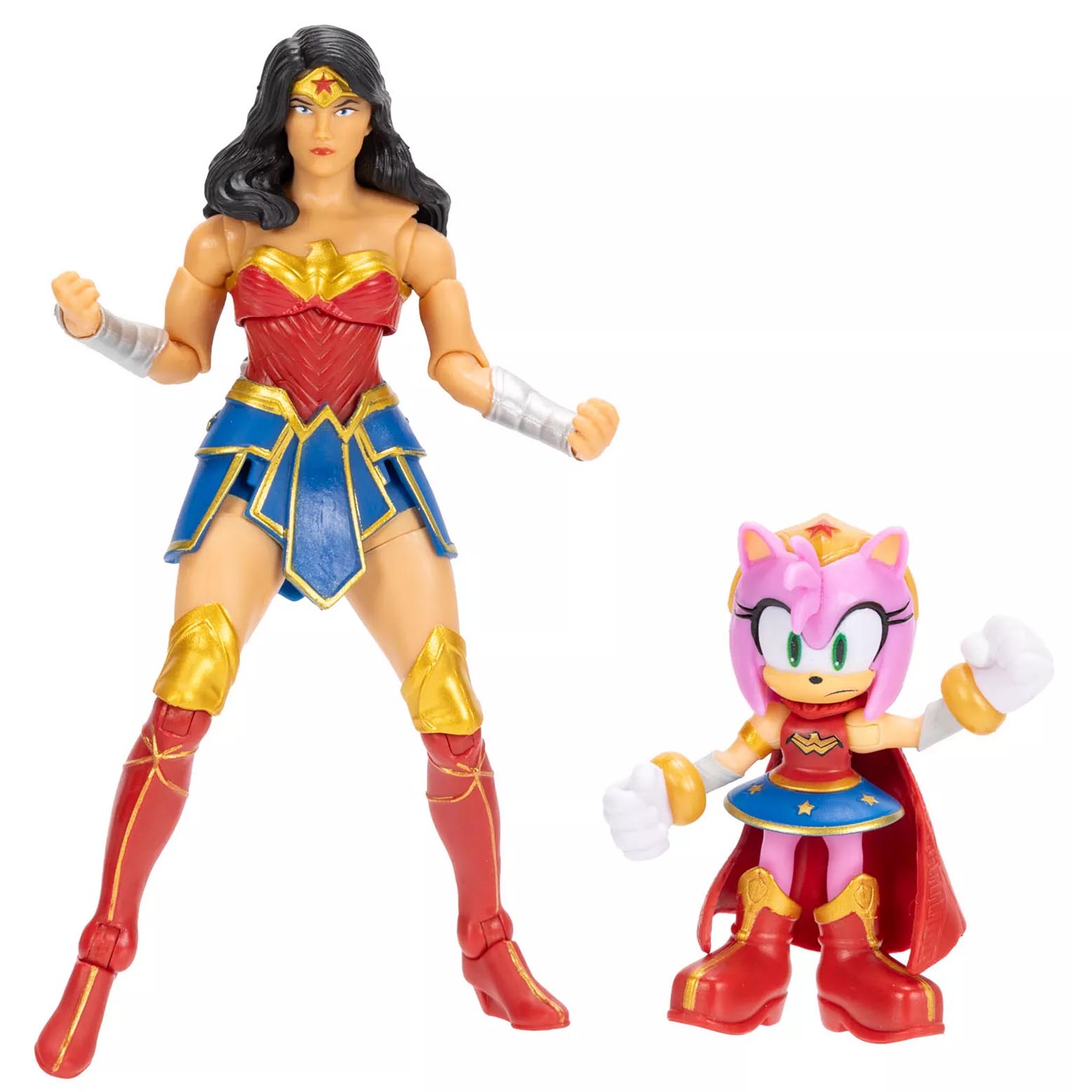 Two action figures are shown: one of a woman in a gold, red, and blue outfit resembling superhero attire, and a smaller pink character with a similar theme, featuring a cape, gold boots, and a blue skirt.