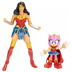 Two action figures are shown: one of a woman in a gold, red, and blue outfit resembling superhero attire, and a smaller pink character with a similar theme, featuring a cape, gold boots, and a blue skirt.