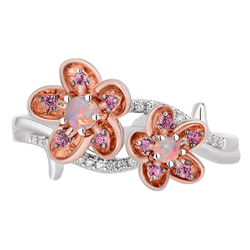 A floral ring with two rose gold flowers, featuring central opal stones and pink gemstones on the petals. The band is silver with additional small clear stones.