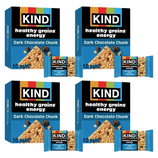 Four boxes of KIND Healthy Grains Energy Bars in Dark Chocolate Chunk flavor, each containing 10 bars, are displayed with a single bar in front of each box.
