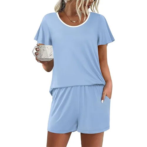 Light blue short-sleeve loungewear set featuring a round neckline and matching shorts with pockets. A woman is holding a mug.
