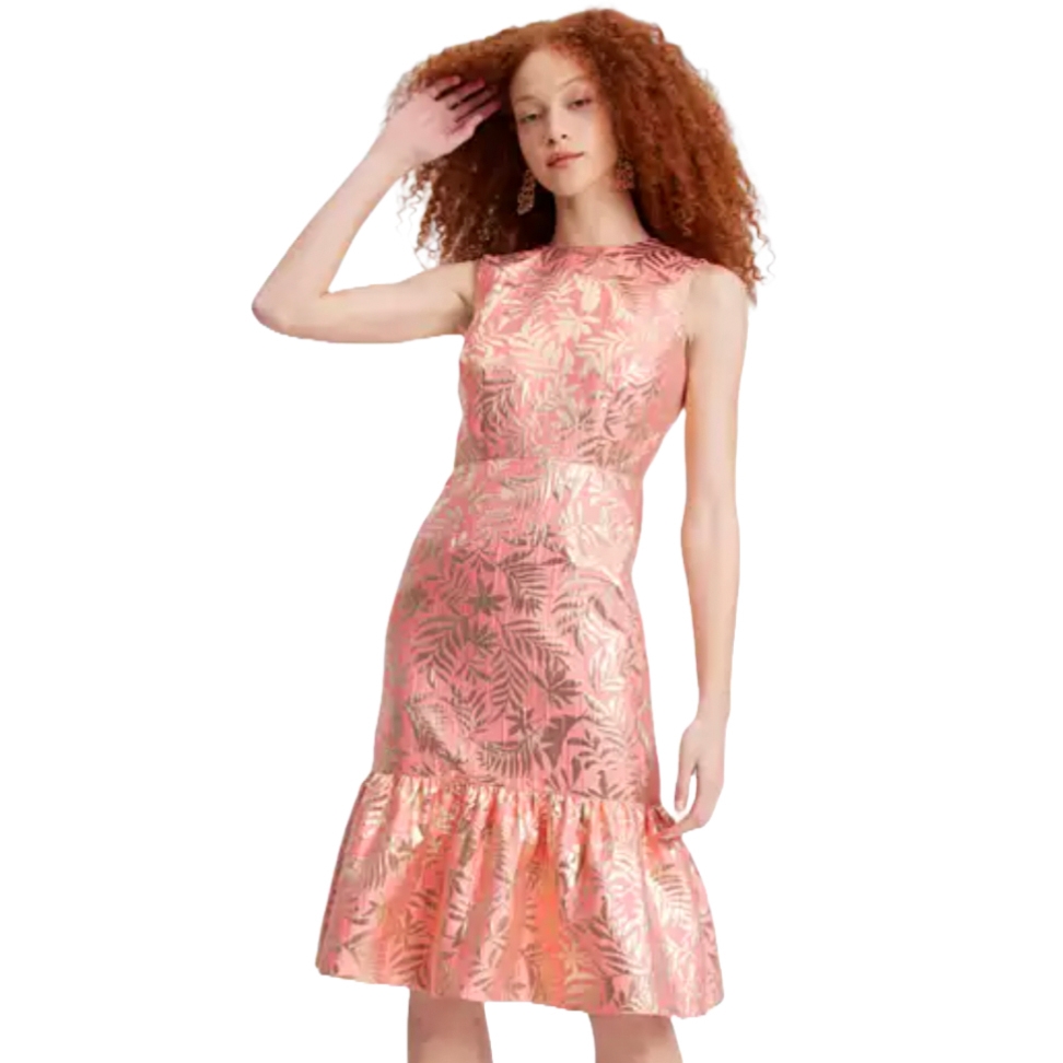 A woman is wearing a sleeveless, pink floral pattern dress with a fitted bodice and ruffled hem.