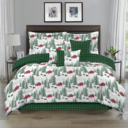 A bedding set with a woodland theme, featuring green plaid patterns and designs of red trucks, trees, and black bears. The set includes pillows, a comforter, and a bed skirt.