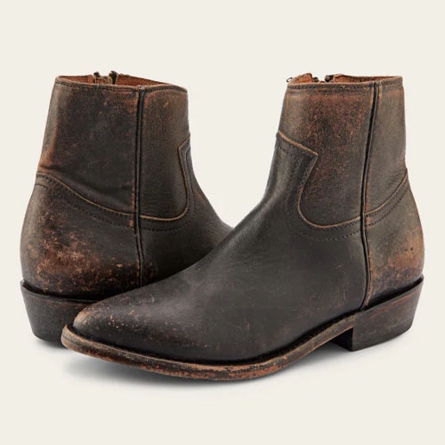 A pair of worn brown leather Chelsea boots with slight heels.