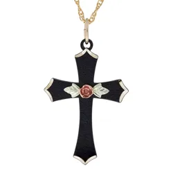 A black cross pendant features a rose and leaf embellishment, with gold accents on the edges, hanging from a gold chain.