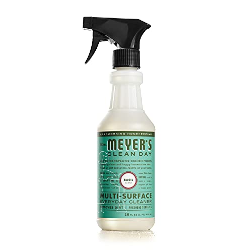 A bottle of Mrs. Meyers Clean Day Multi-Surface Everyday Cleaner with a basil scent, featuring a spray nozzle and green label.