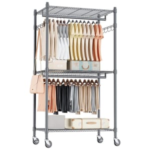 A rolling clothing rack with two tiers of hanging space features assorted clothes and a handbag. It includes wire shelves for storage and stands on four caster wheels for easy mobility.