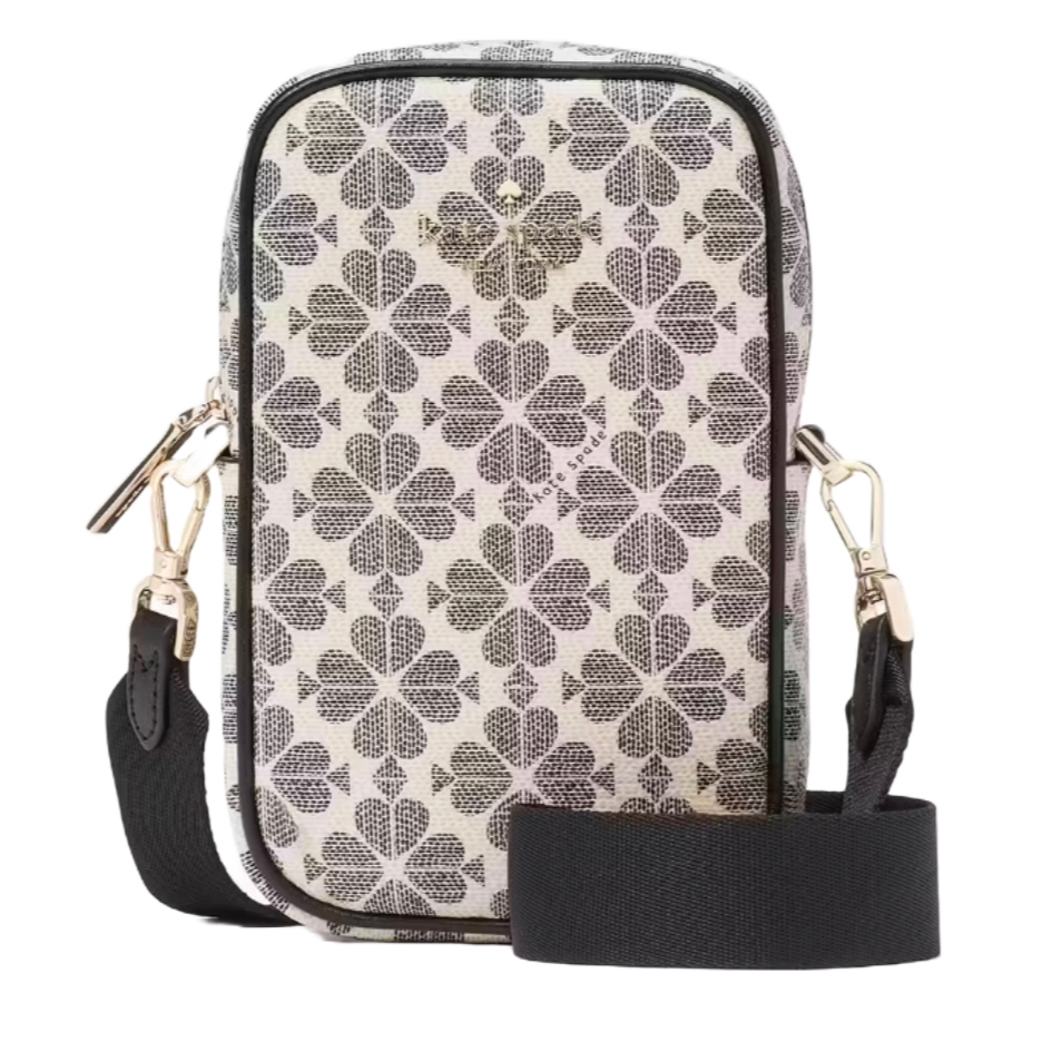 A rectangular crossbody phone bag with a black and white clover pattern, featuring a detachable black strap and gold-tone hardware, including a zipper and clasps.