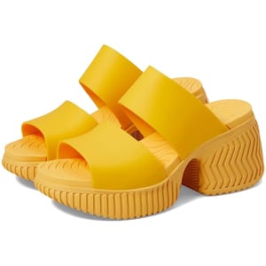 Yellow platform slide sandals with wide straps and textured soles, featuring a chunky heel with a zig-zag pattern for added style and traction.