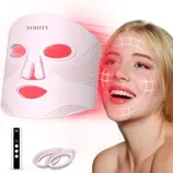 LED face mask for skincare with a remote control, emitting red light therapy, shown with additional eye inserts.