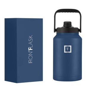 A blue IRON °FLASK water bottle with a black handle and spout next to its packaging box.