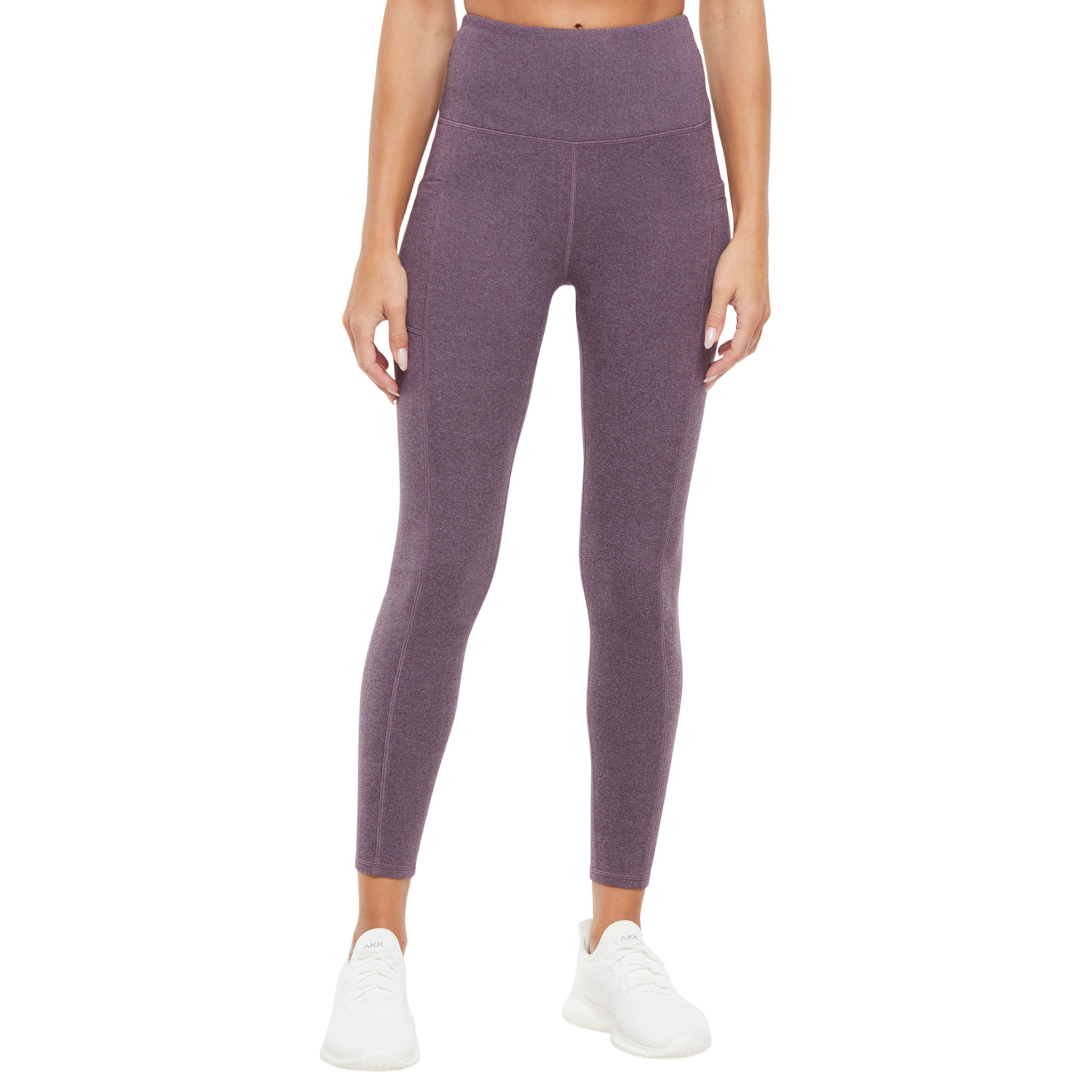 High-waisted purple leggings with side pockets, paired with white athletic sneakers.