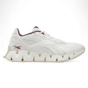Reebok Zig Dynamica 4 Shoes feature a white design with maroon accents and a distinctive zigzag-shaped sole for enhanced cushioning and style.