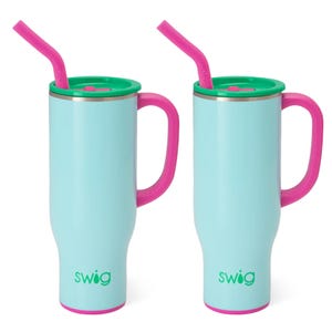 Two 30oz light blue thermal mugs with handles, featuring pink rims, handles, and straws, and green lids. Designed by Swig, they provide insulated beverage storage.