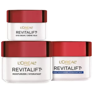 L'Oreal Paris Revitalift 3pc Skincare Set includes an Eye Cream, a Moisturizer, and a Night Moisturizer, each with red lids and white jars, designed for hydrating and revitalizing the skin.