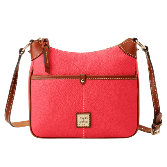 A coral leather crossbody bag with brown accents, featuring a front pocket and adjustable strap. The brand logo, \“Dooney & Bourke,\“ is displayed on a small plaque.
