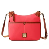 A coral leather crossbody bag with brown accents, featuring a front pocket and adjustable strap. The brand logo, \“Dooney & Bourke,\“ is displayed on a small plaque.