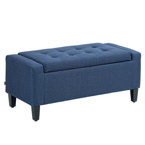 A blue upholstered storage ottoman bench features a cushioned, tufted lid and four black legs, offering seating and hidden storage.