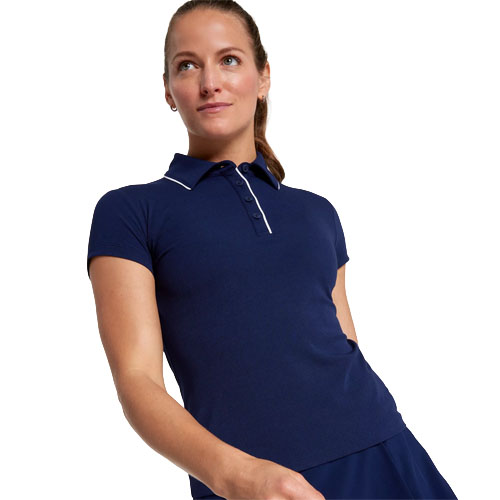 A woman wearing a navy blue short-sleeved polo shirt with a buttoned collar and white piping detail, paired with a matching skirt.