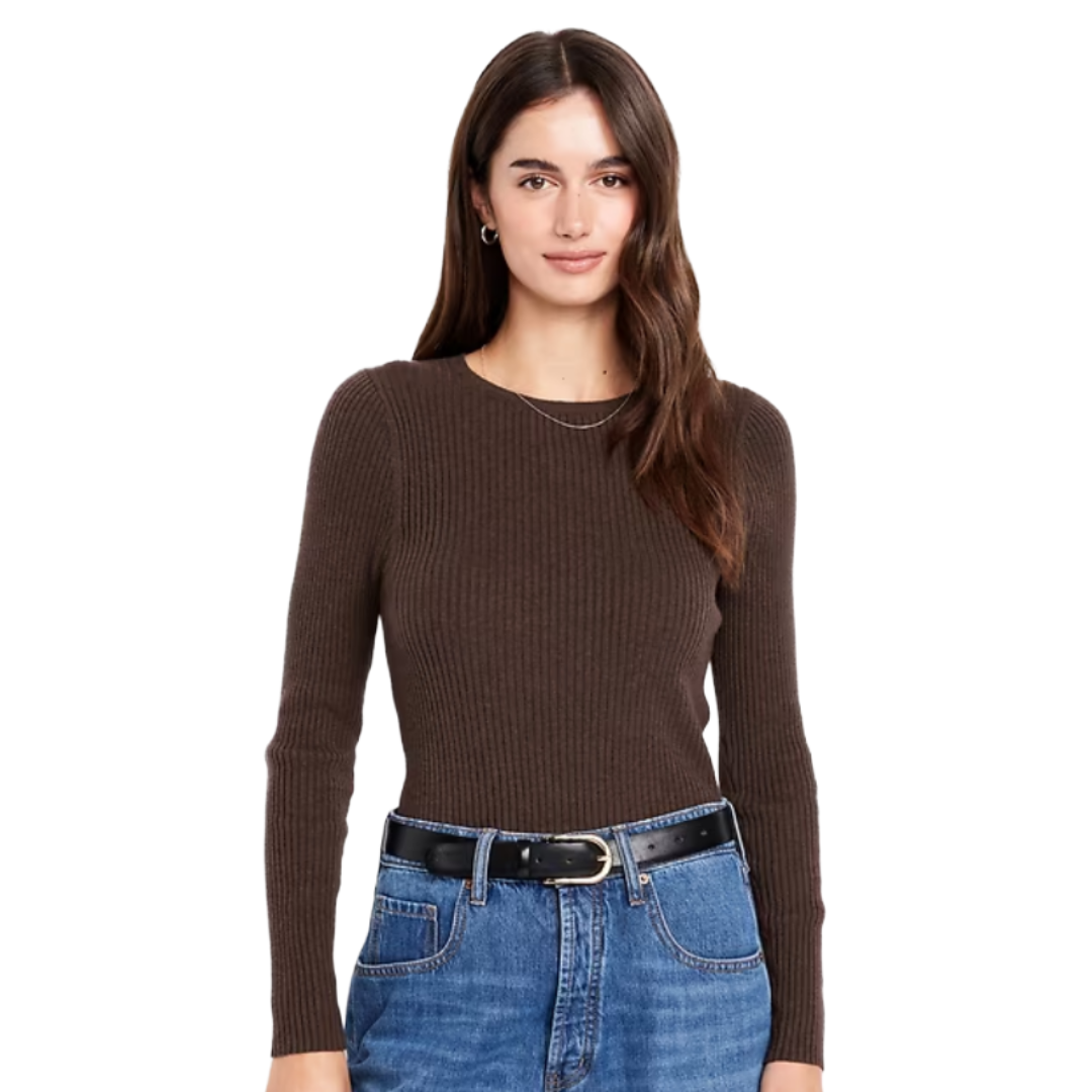A woman is wearing a dark brown ribbed sweater and blue jeans, accessorized with a thin necklace and a black belt.