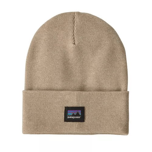 A beige beanie with a folded brim featuring the Patagonia logo and mountain icon in purple, blue, and black.