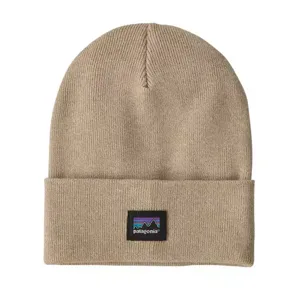 A beige beanie with a folded brim featuring the Patagonia logo and mountain icon in purple, blue, and black.