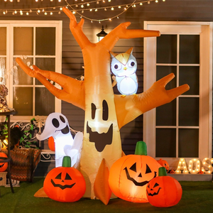 Inflatable Halloween decorations featuring a smiling ghost, pumpkins with faces, an owl, and a spooky tree, set against a house with fairy lights.