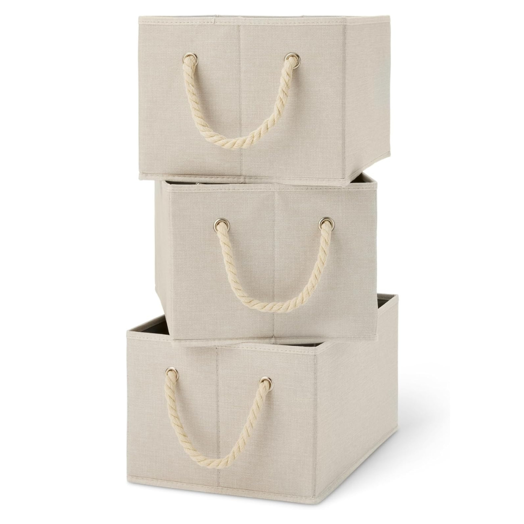 Three beige fabric storage bins with rope handles, stacked on top of each other.