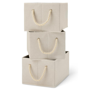 Three beige fabric storage bins with rope handles, stacked on top of each other.