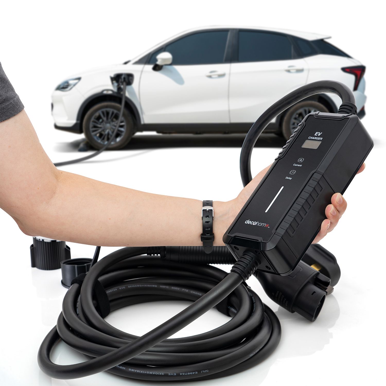 An electric vehicle (EV) charger with a handheld connector and a white car in the background.