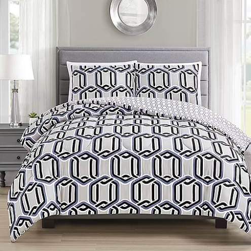 A bedding set featuring a geometric hexagonal pattern in black, white, and grey, with matching pillowcases, displayed on a grey upholstered headboard bed.