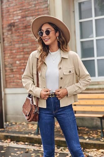 A woman is wearing a beige corduroy shacket with two chest flap pockets, paired with a white top and blue jeans. She accessorizes with a brown hat, sunglasses, and a shoulder bag.