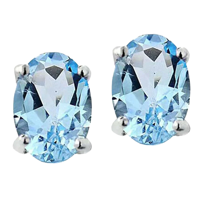 A pair of oval-cut, light blue gemstone earrings set in a four-prong silver setting.
