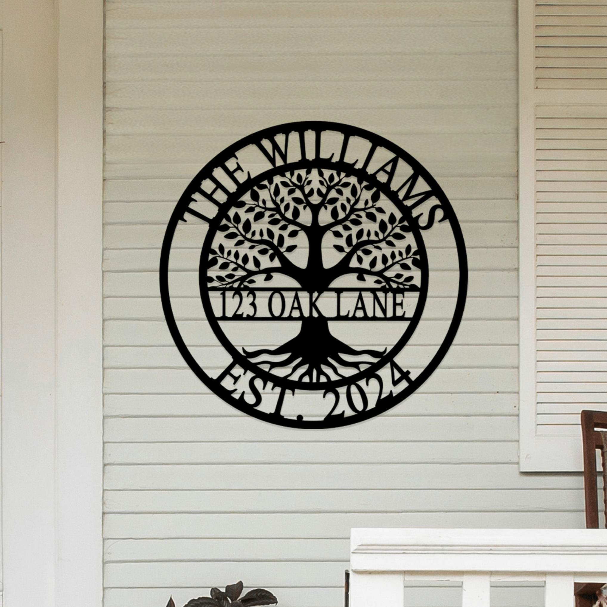 Metal wall sign featuring a tree design with text \“The Williams, 123 Oak Lane, Est. 2024\“ displayed on a house exterior.